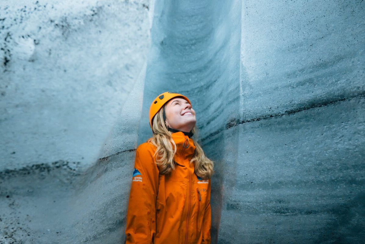 Female standing inside Katla ice cave crevasse.