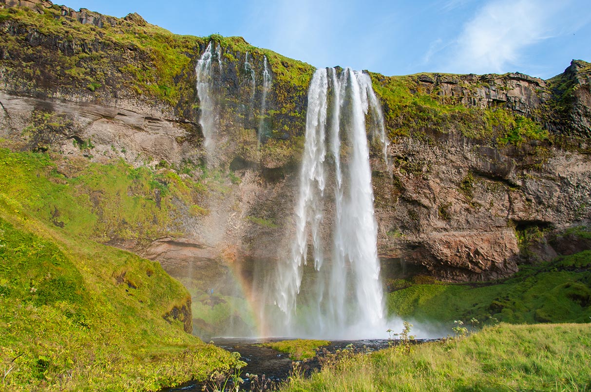 Seljalandsfoss waterfall with rainbow in the spray, South Iceland
