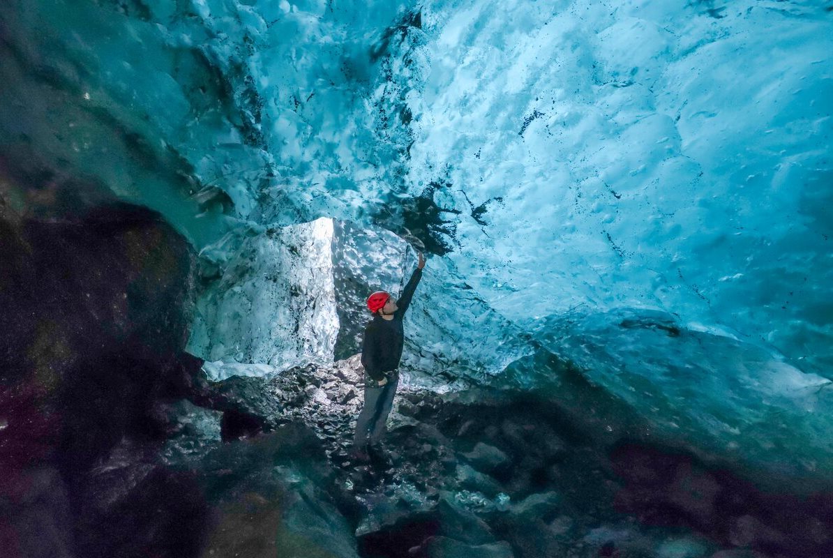Azure Ice Cave Solheimajokull Male standing inside Solheimajokull Azure ice cave.