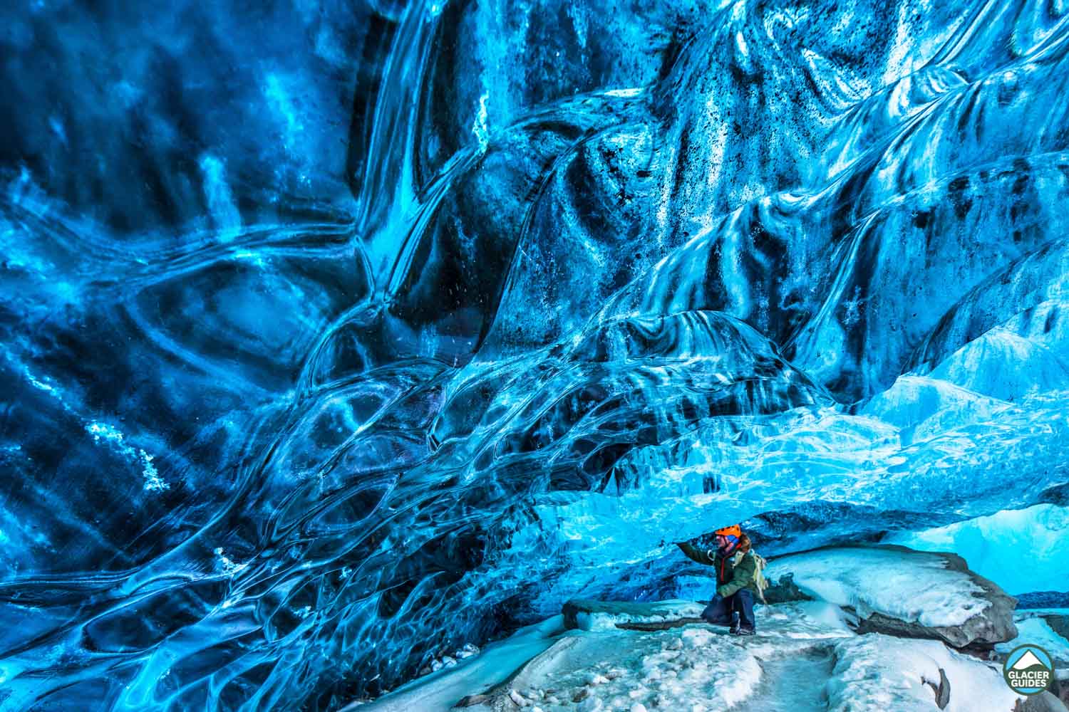 Man Admiring Crystal Ice Cave Wall