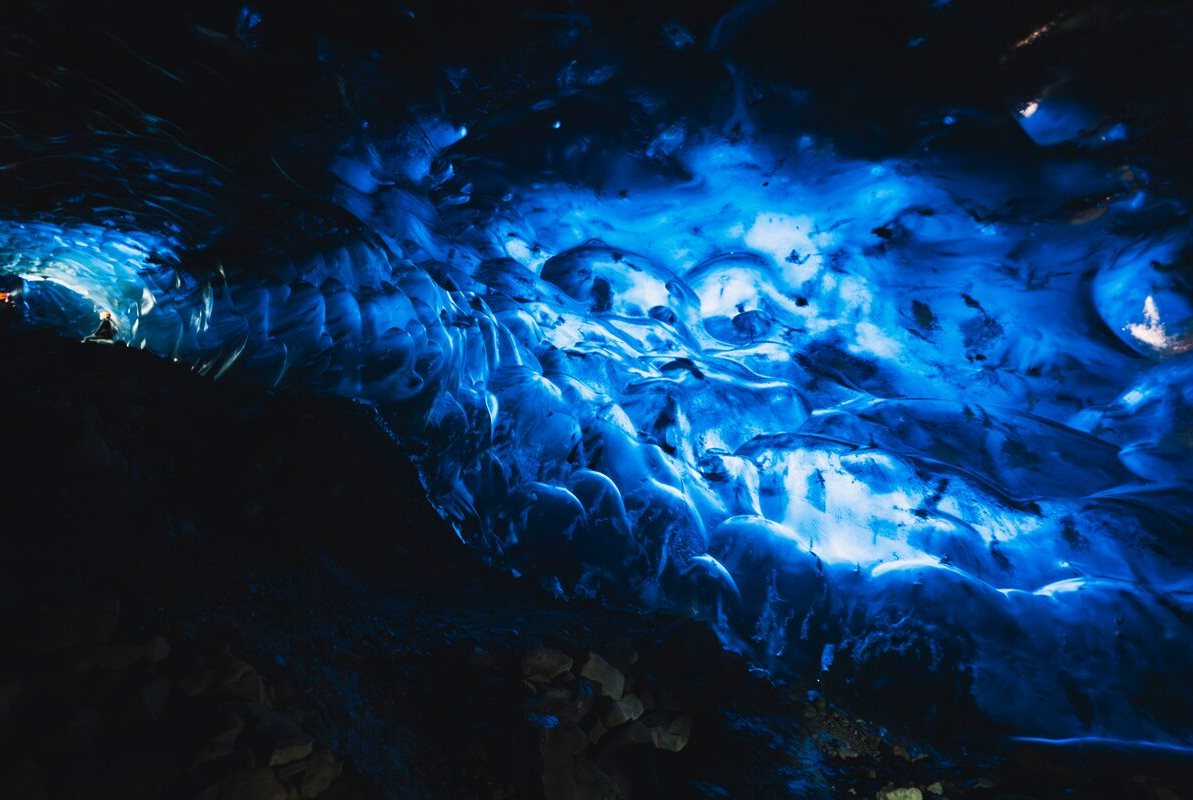Tourists inside bright blue Crystal Cave on small group tour 
