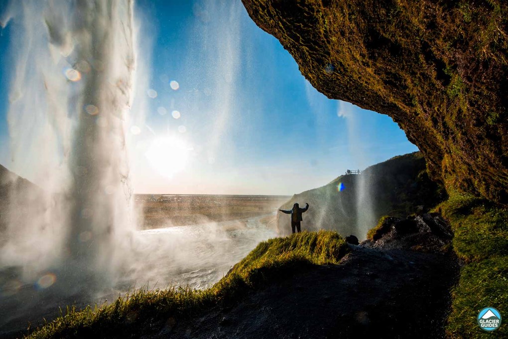 Tourist Standing Under Seljalandsfoss Waterfall