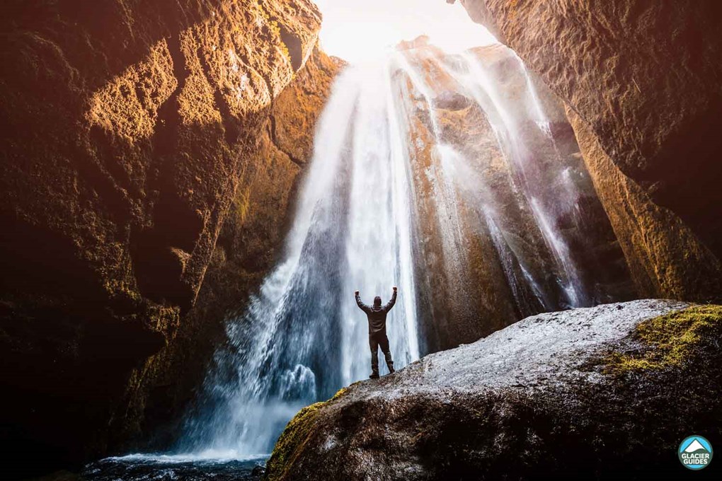 Tourist Standing On Rock Near Gljufrabui Waterfall