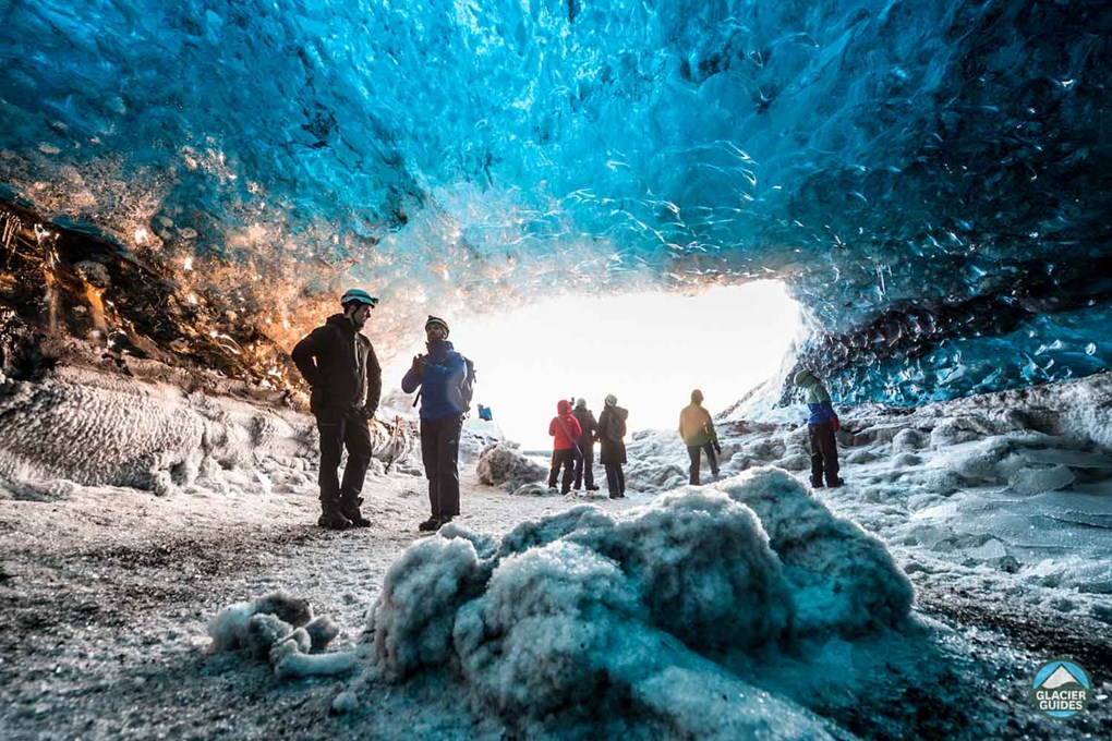 Small People Group At Crystal Ice Cave Entrance