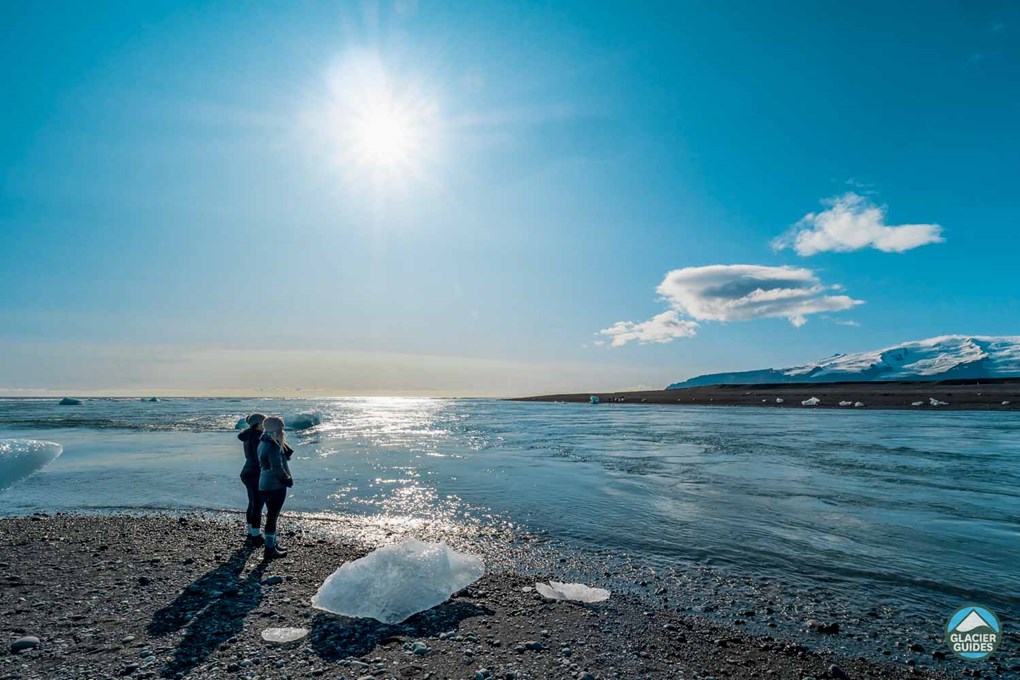 Two People On Diamond Beach In Iceland