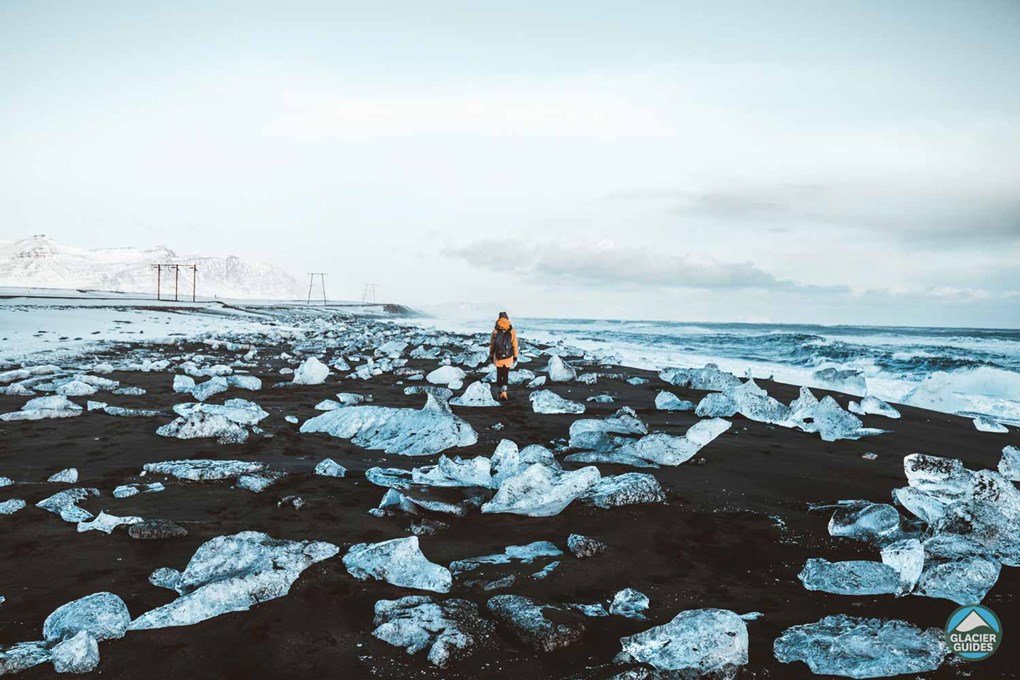 Woman Near Crystal Icebergs In Diamond Beach