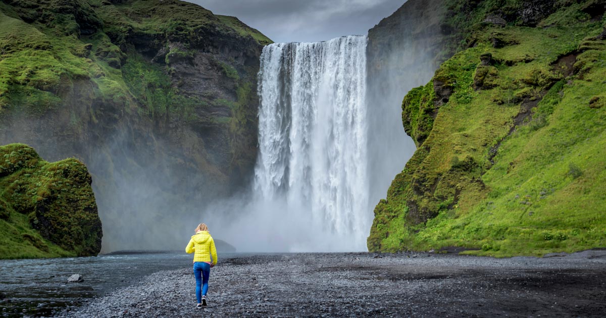 Tourist Approaching Skogafoss Waterfall