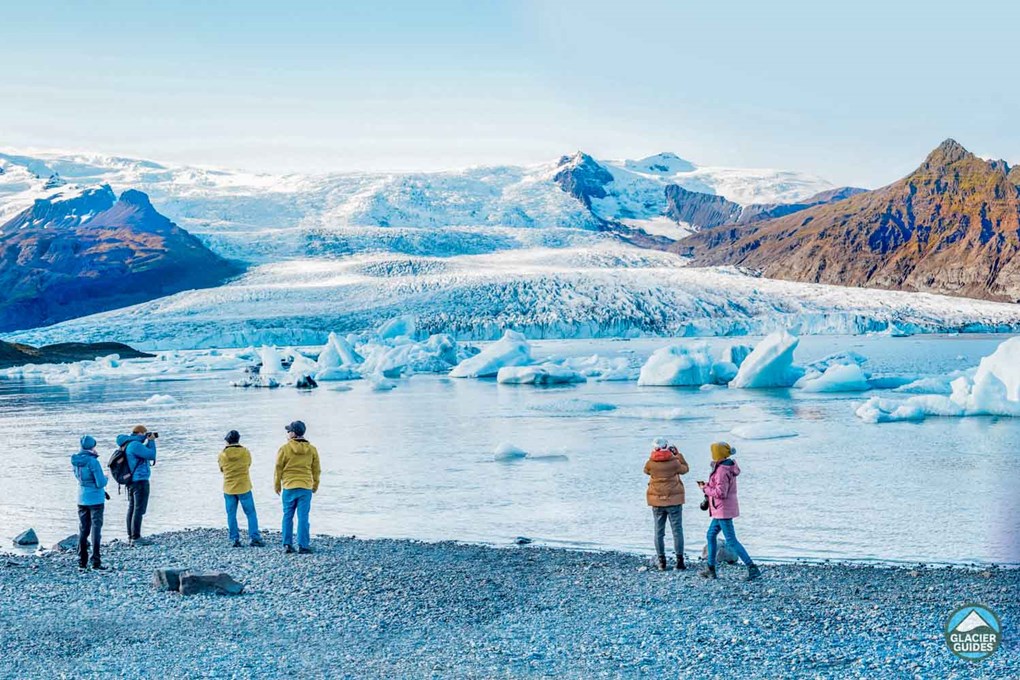 Tourists on the shore of Fjallsarlon Glacier Lagoon