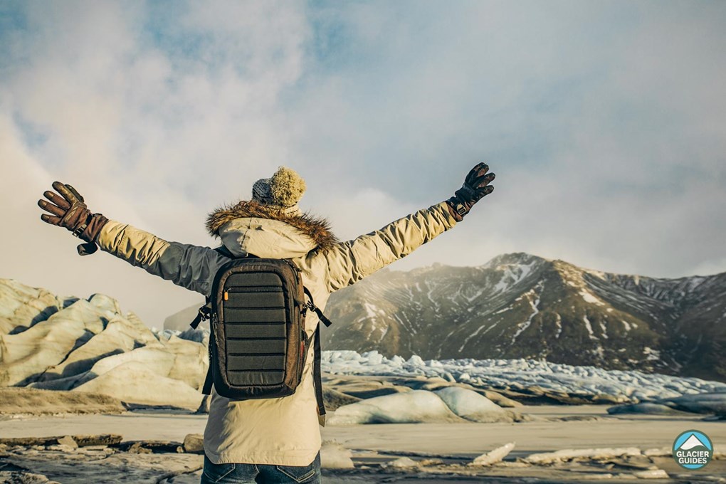 Back view of tourist spread hands in Skaftafell