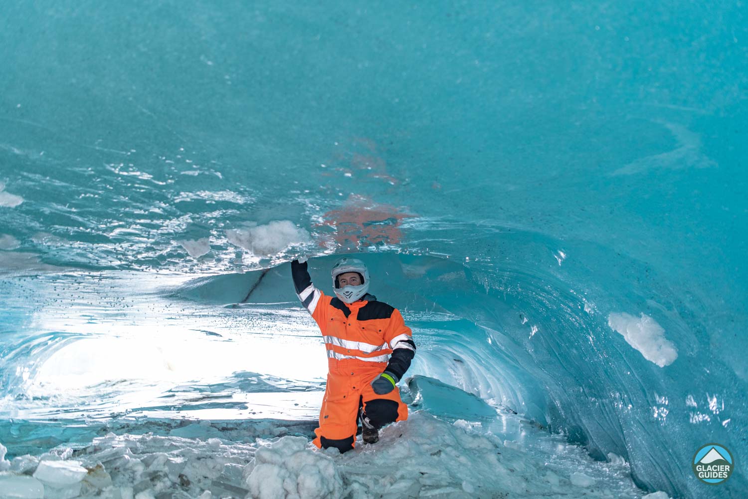 Person With Orange Suit In Langjokull Ice Cave