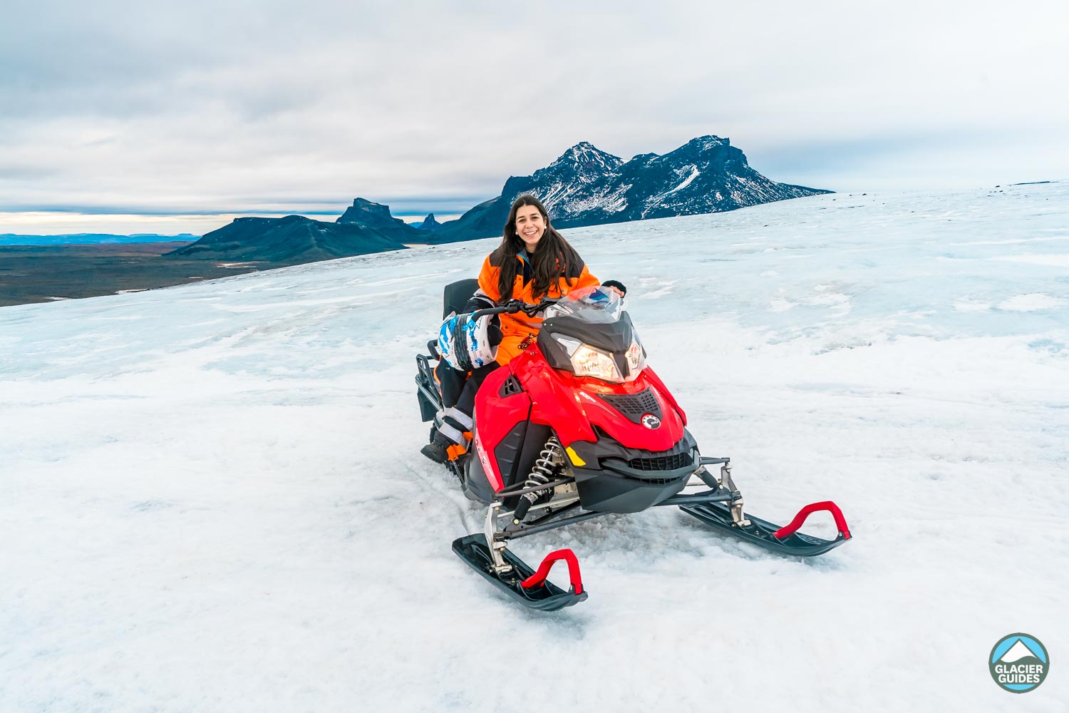Girl On Snowmobile With Orange Suit