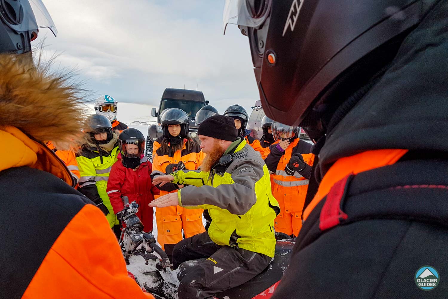 Instructor Teaching Group Before Snowmobile Tour