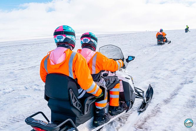 People Snowmobiling in Iceland