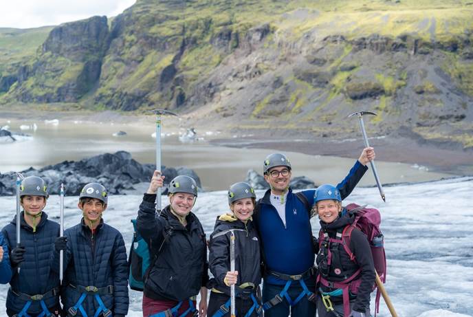 Group of people on glacier in Iceland People posing for photo on glacier