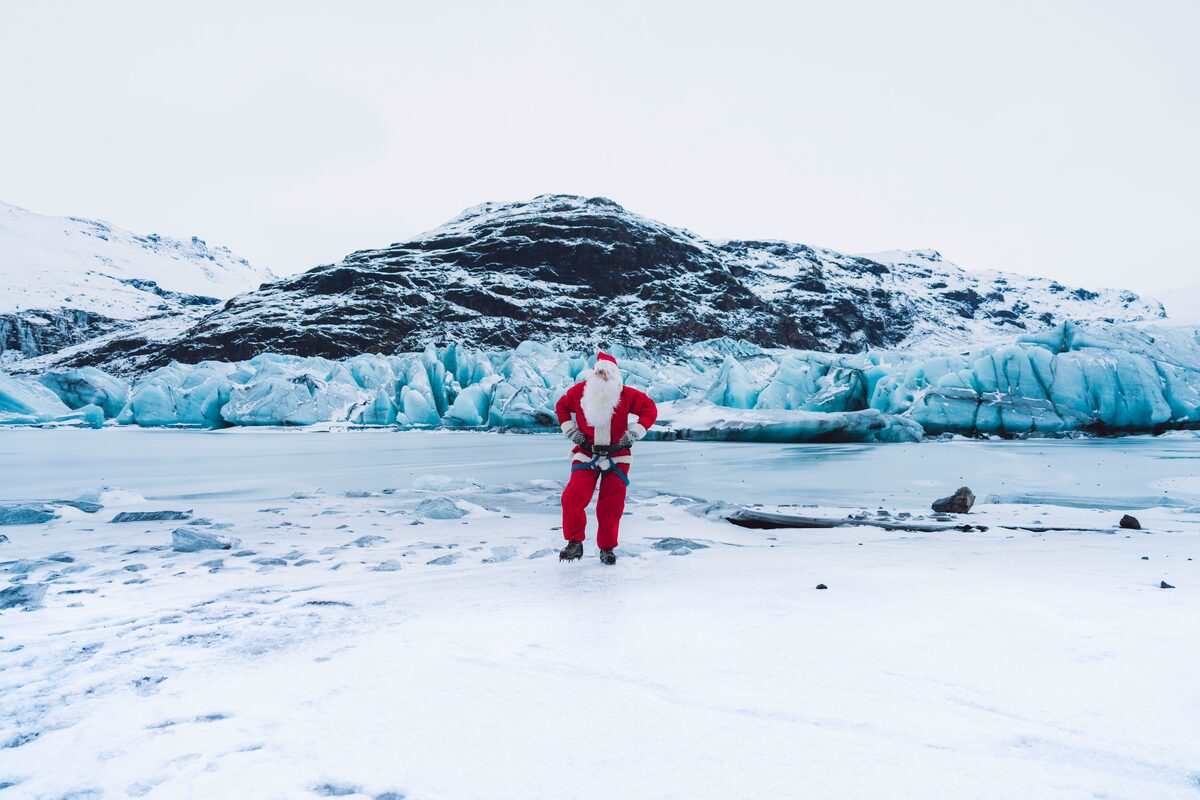 santa posing for photos on a glacier in iceland