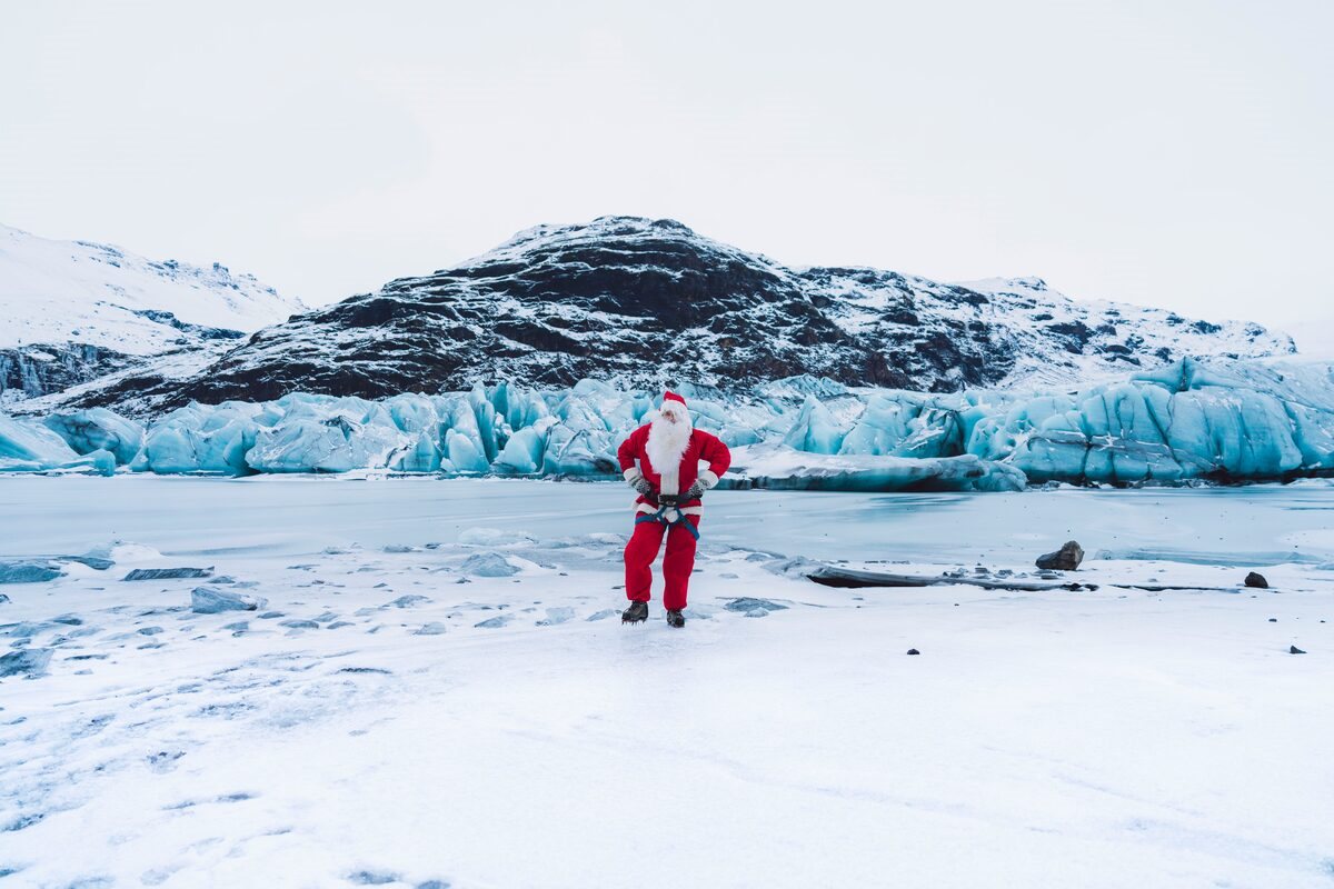 santa posing for photos on a glacier in iceland