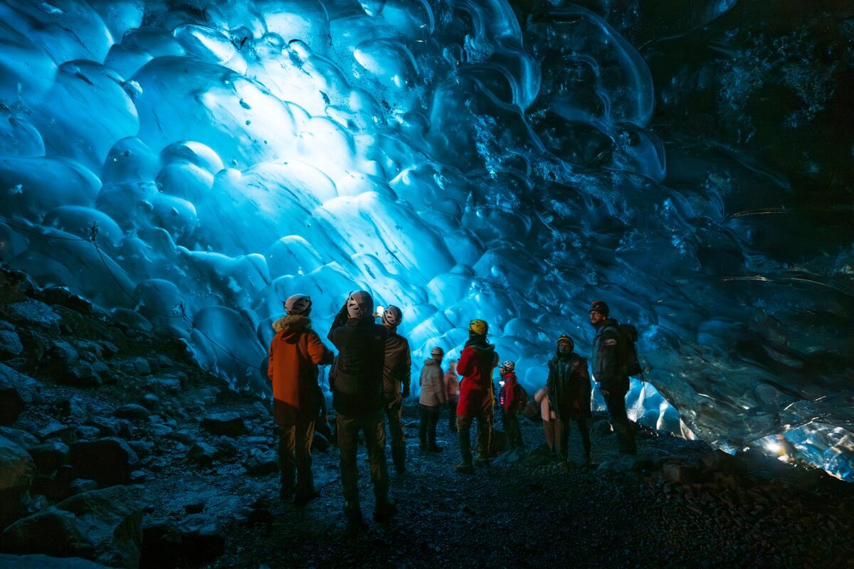tourists at crystal ice cave in iceland