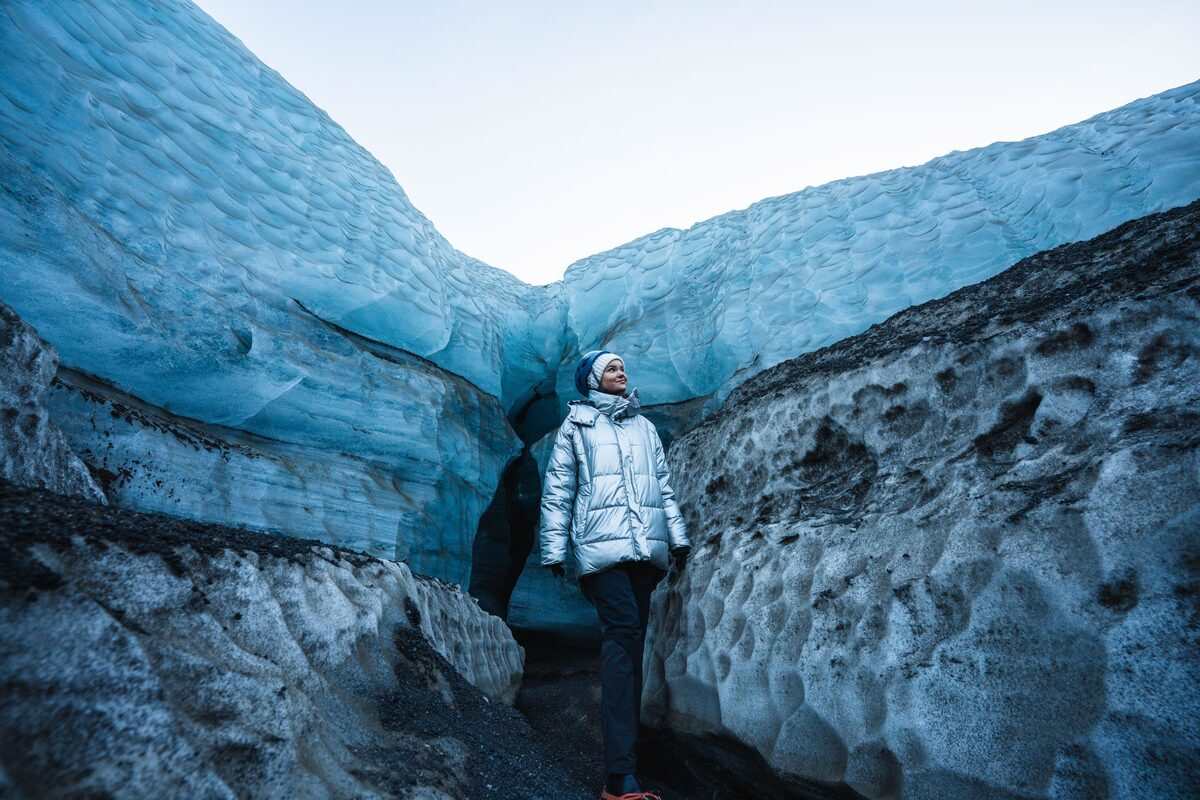 woman outside of katla ice cave in iceland