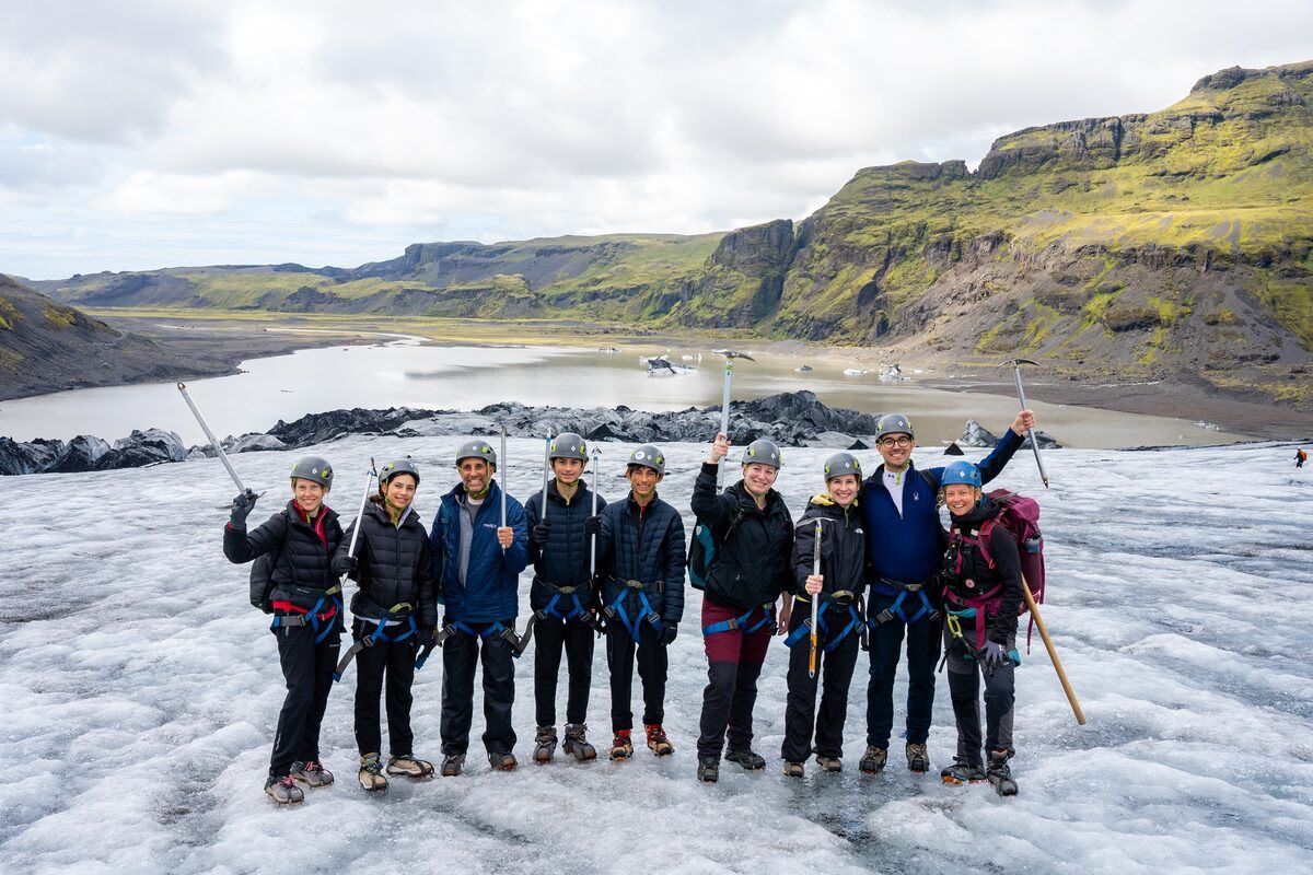 group of glacier hikers posing happy in iceland