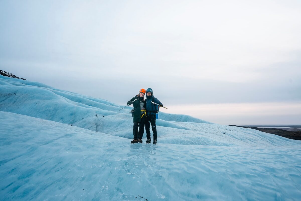 A Couple With Pickaxes On An Icy Glacier in Iceland