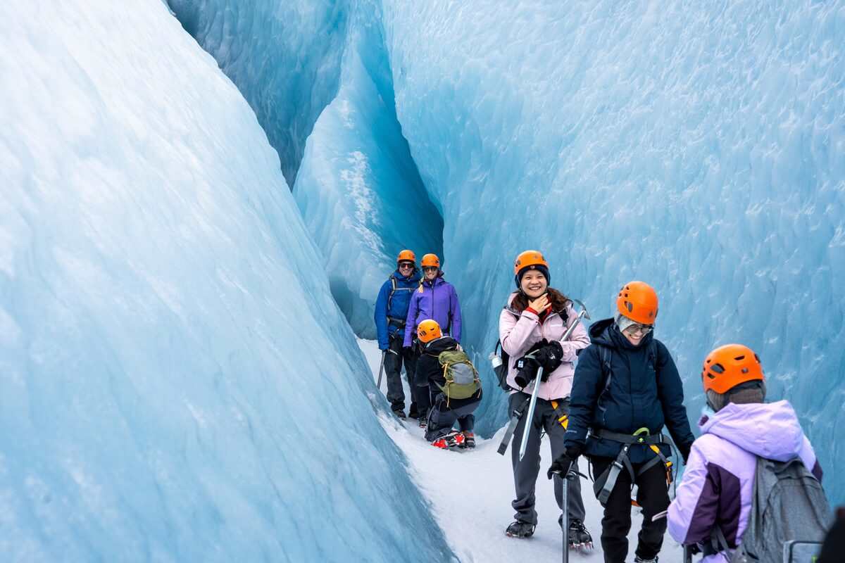 Group Of People On A Glacier Hike Going Through Glacier Crevasses in Iceland